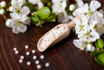 homeopathic pills with spring flowers 