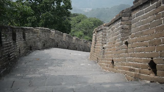 Great Wall of China atop the mountains in the forest, showing air pollution and smog, China. HD Video