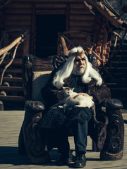 Old druid sits in chair