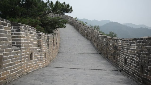 Great Wall of China atop the mountains in the forest, showing air pollution and smog, China. HD Video
