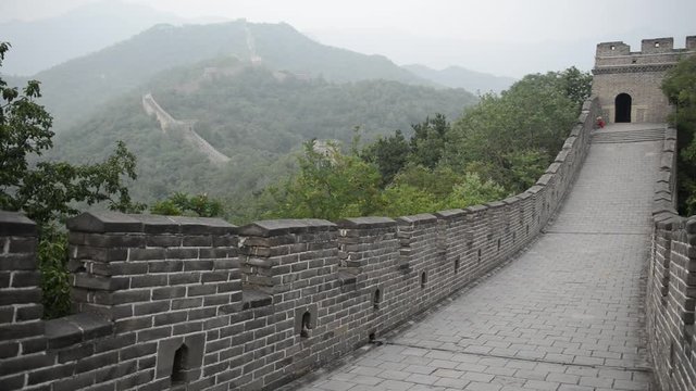 Great Wall of China atop the mountains in the forest, showing air pollution and smog, China. HD Video