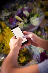 Male florist text messaging on mobile phone © WavebreakmediaMicro