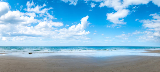 Tropical sandy beach with clear sky.