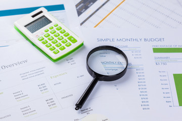 work with a magnifying glass, a calculator and papers