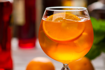 Orange drink in wineglass. Slice of fruit and ice. Chilled aperol spritz. Dry wine and soda water.