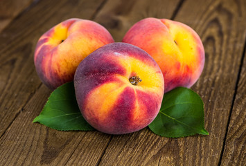 fresh peaches on wood background