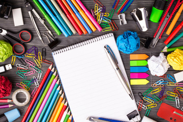 Bunch of office supplies on wooden desk