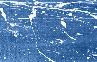 Blue concrete wall with white paint drips and drops background