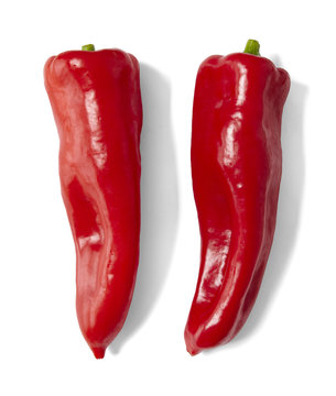 Two red sweet Mirabella peppers isolated on a white background