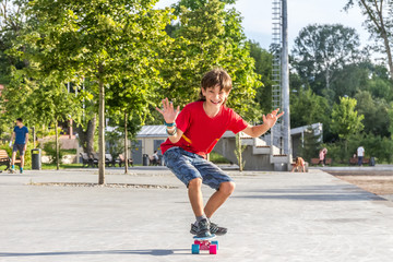 Fototapeta premium outdoor portrait of young smiling teenager boy riding short mode