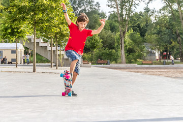 outdoor portrait of young smiling teenager boy riding short mode