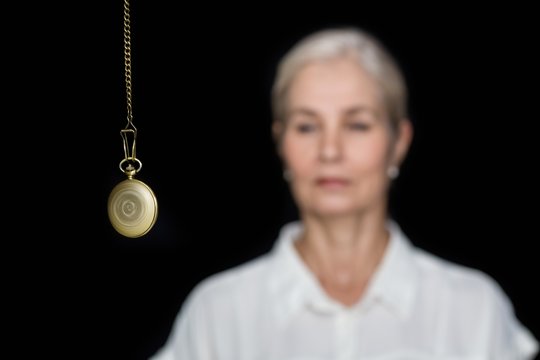 Woman being hypnotized with pendulum 