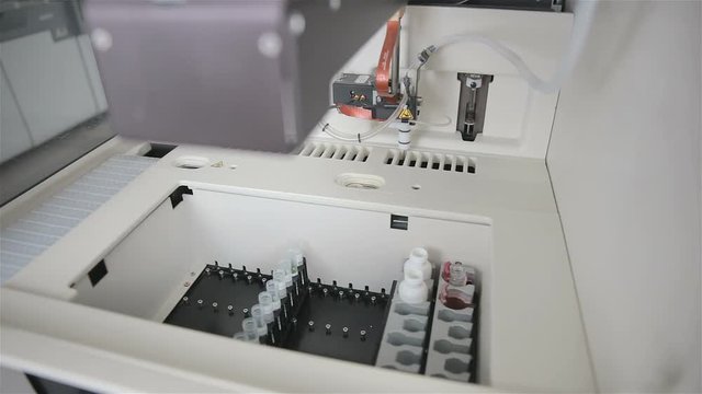 High-tech robotic pharmaceutical, medical machine automatically working in modern lab. Slider shoot.