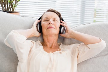 Close-up of mature woman listening to music