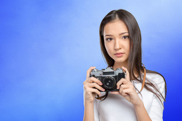 Woman using a retro photo camera
