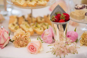 Obraz na płótnie Canvas Dessert table for a party. Eclairs, cake, cupcakes, sweetness an