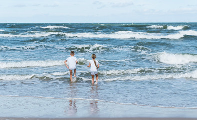 boy and girl on the sea waves © Maksim Shebeko