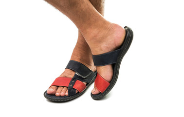 Men's feet in leather sandals