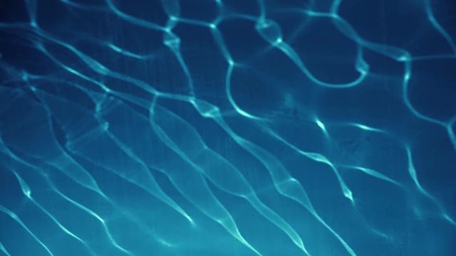 Clear Blue Transparent Water Reflecting The Sun With Slight Waves