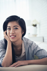 Portrait of mixed-race young woman resting at home