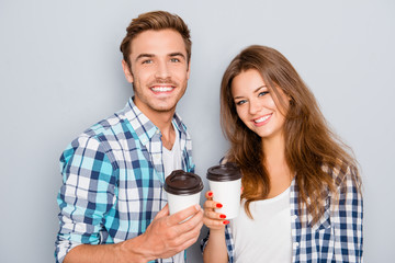 Portrait of happy young couple in love drinking coffee