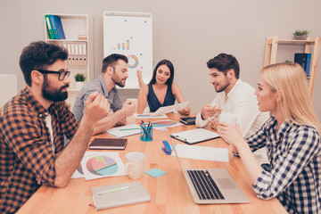 young managers conversing at conference table, they planning new