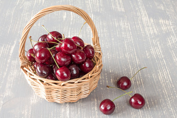 Fototapeta na wymiar Wicker basket full of fresh cherries