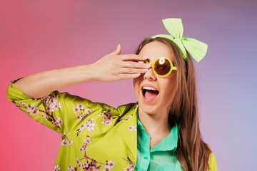 Portrait of a cheerful young girl in bright casual clothes smili