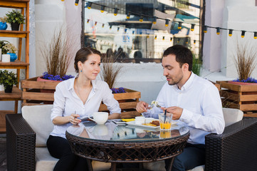 Happy business people on their lunch outside at the coffee shop