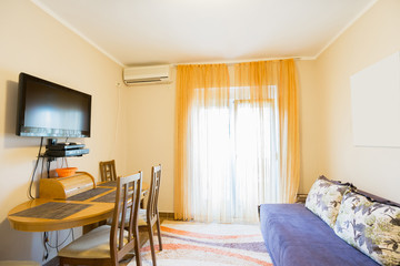 Interior of a guest house living room with a kitchen