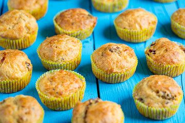 Fresh Baked Muffins with Cheese and Sun-dried Tomatoes on Blue Wooden Background