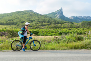 Obraz premium Girl riding on the bike in the Crimea.