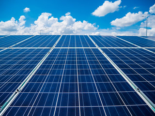 Solar panels with blue sky and clouds