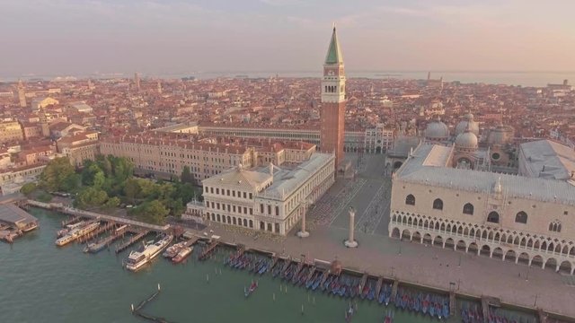 Amazing aerial view of tradiconal gondolas on Piazza San Marco and The Doge's Palace embankment.