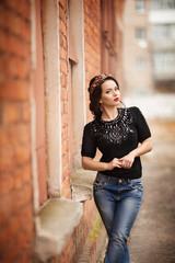 Portrait of beautiful young woman with makeup in fashion clothes