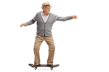 Joyful senior man riding a skateboard