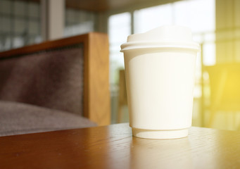 Fototapeta na wymiar coffee cup in coffee shop with burst light