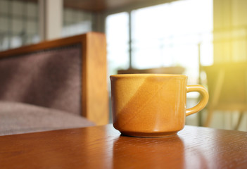 Coffee on wooden table with burst light