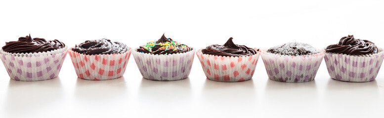 Cup cakes in a row on a white background