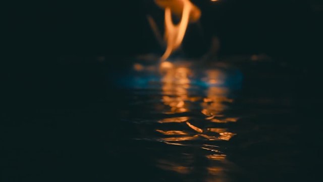 A lit match ignites gasoline. Blue Wave at the forefront of fire go to meet. S-log - High Dynamic Range. Slow motion, high speed camera, 250fps