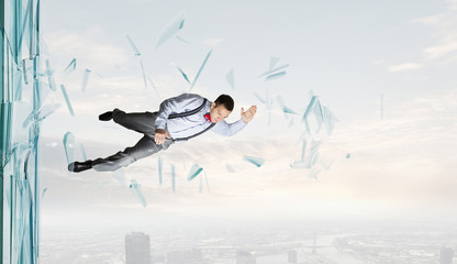 Fototapeta premium Man breaking through glass . Mixed media