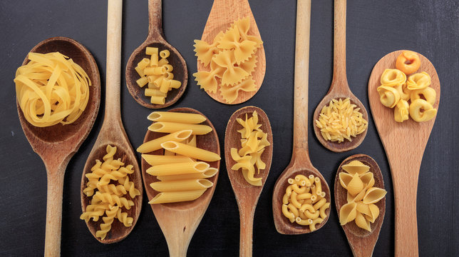 Various shapes of pasta on a black background