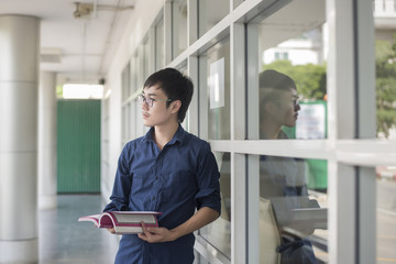 Fototapeta na wymiar A portrait of an Asian university student on campus