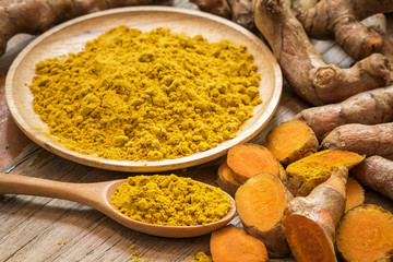 fresh turmeric roots with turmeric powder