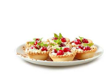 Tartlets with whipped cream and cherry.