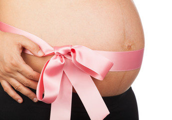 Pregnant woman with pink ribbon around her belly
