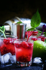 Raspberry-lime chilled lemonade, dark background selective focus