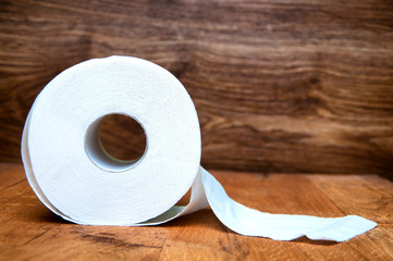 Toilet paper on wooden background