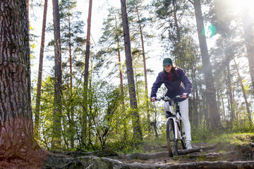 Obraz premium Bike riding - woman on bike in forest