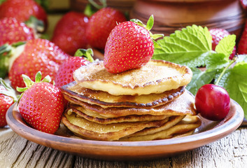 Homemade pancakes with fresh strawberries, selective focus